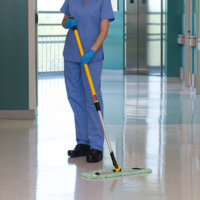 healthcare worker in gloves cleaning the floors