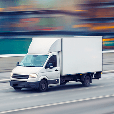 Dependable Delivery a moving-truck looks to be on the highway, the background is blurred to depict its speed