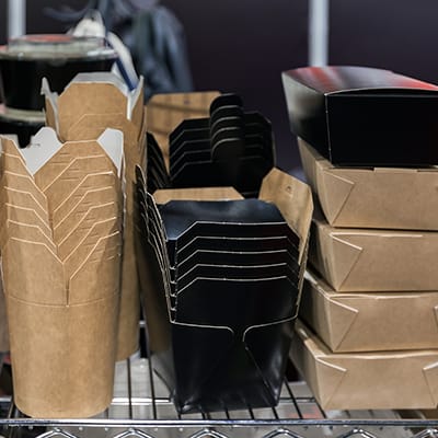 stacks of paper and cardboard containers on a rack