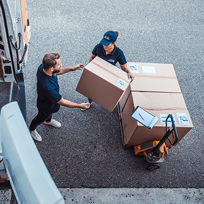 a package delivery professional hands off packages to a man