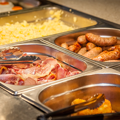 a display of different breakfast foods in a buffet style