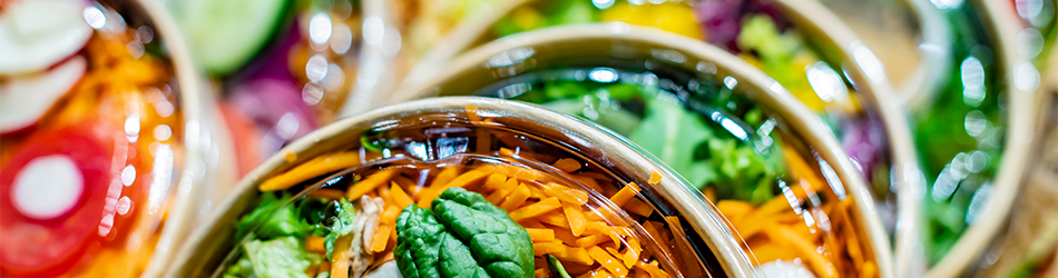 Fresh Choices for an Impactful Customer Experience A close-up panoramic view of various colorful fresh salads in clear plastic containers.