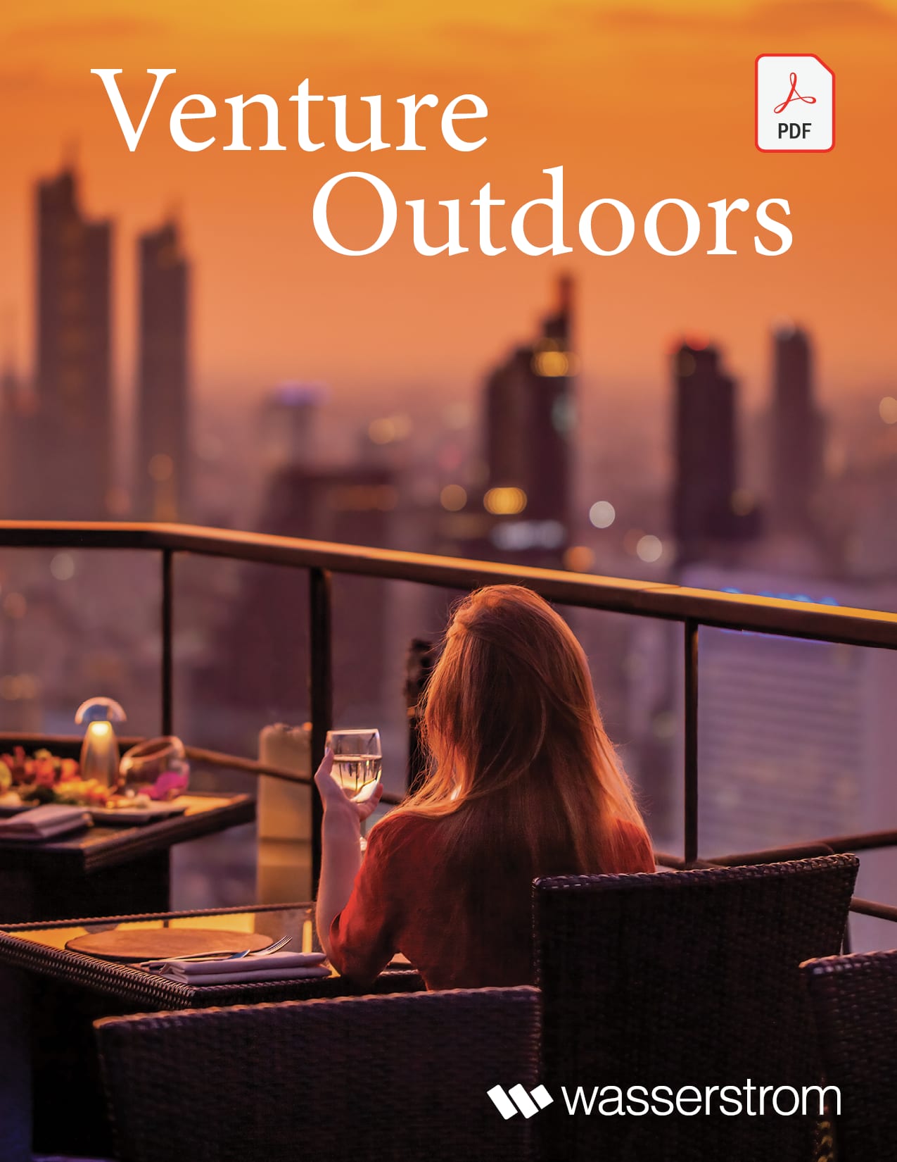 woman drinking wine overlooking the city at sunset