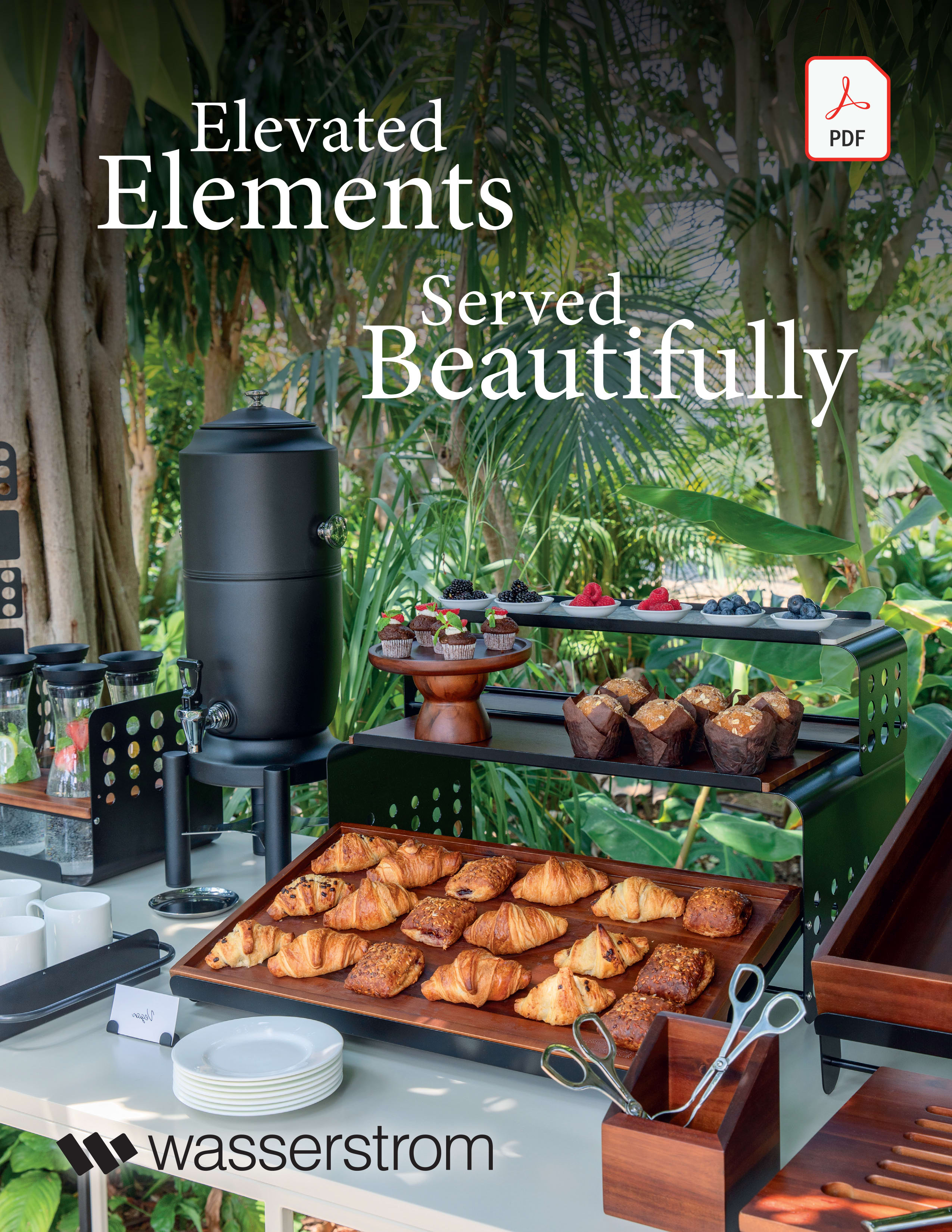 Food displayed in matching buffetware. Greenery decorates table and background