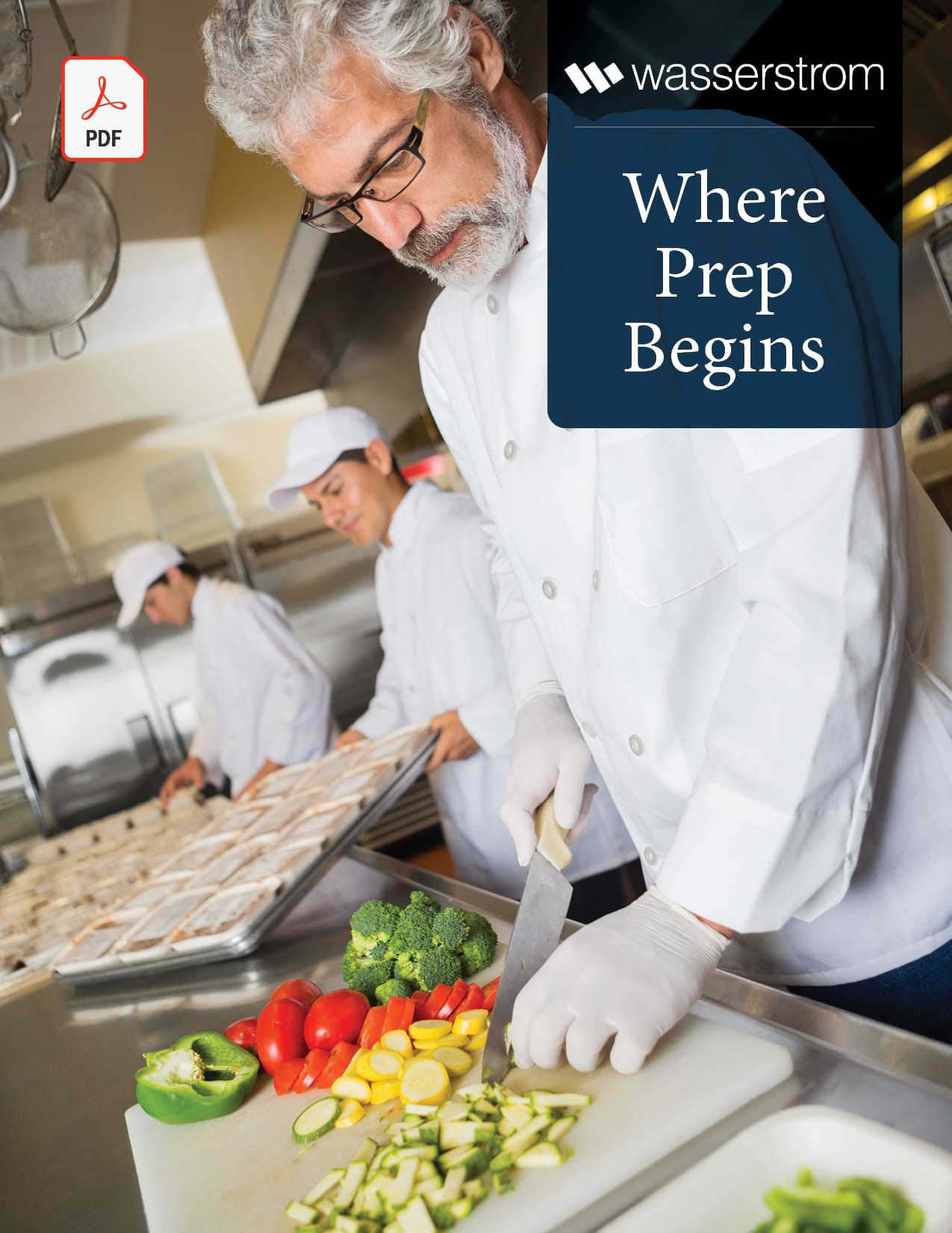 Cooks preparing vegetables and trays of food